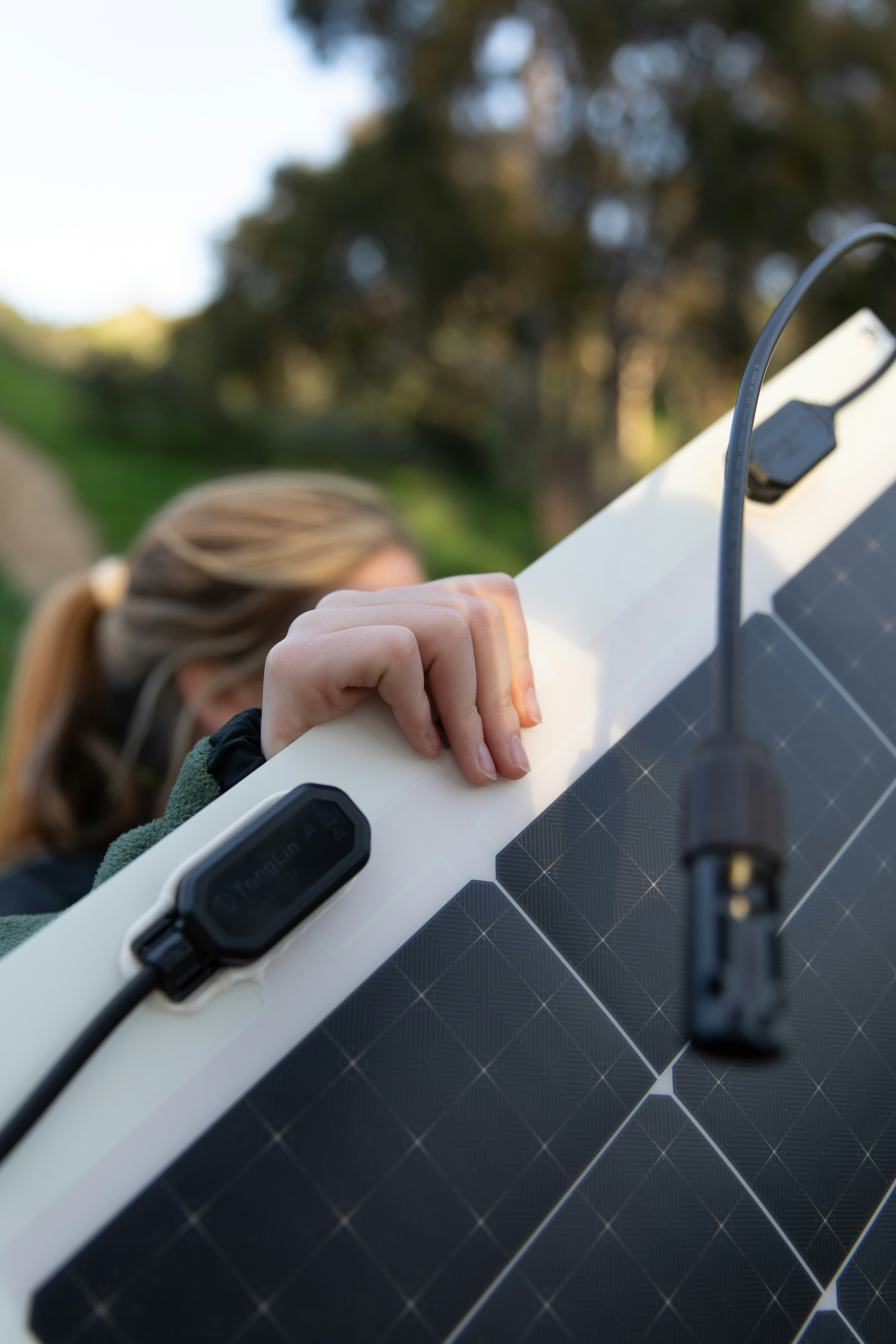 A person handling a flexible solar panel, demonstrating how lightweight and easy to manoeuvre modern plug-in solar panels are for balcony or garden installation