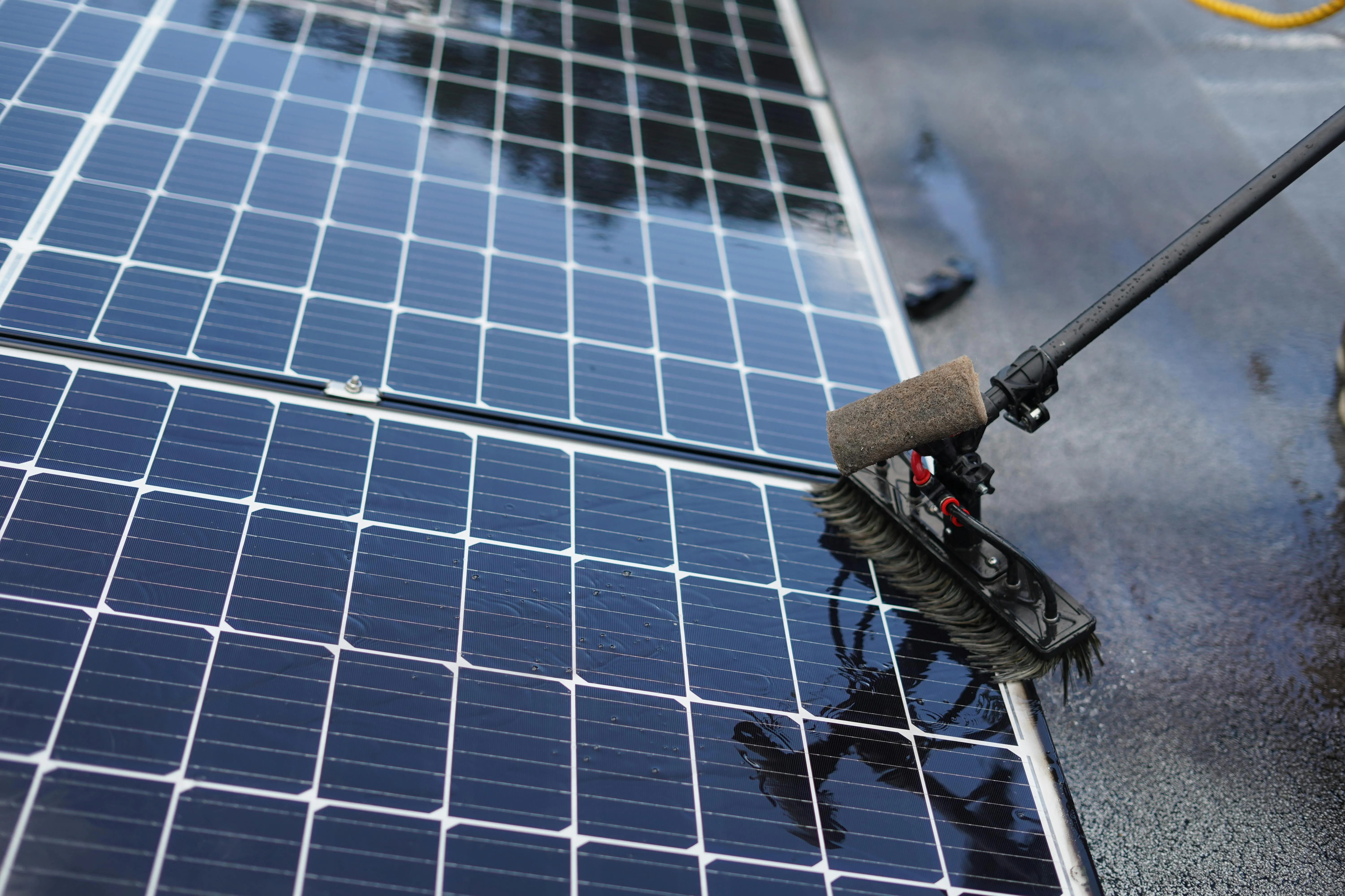 Solar panels being cleaned with water - simple maintenance that keeps plug-in solar systems running at peak performance